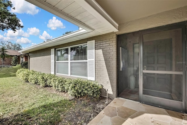 entrance to property with a lawn