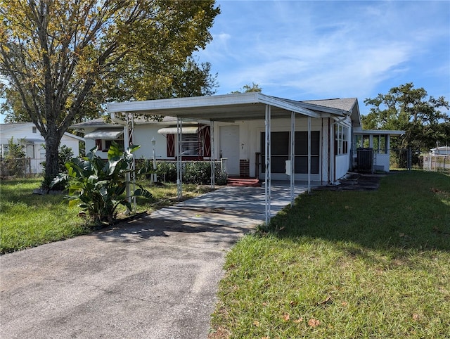 view of front facade with a front yard and a carport