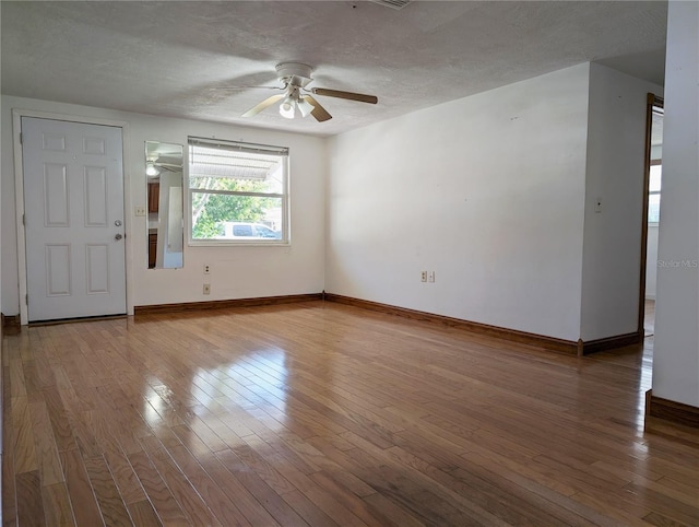 unfurnished room featuring hardwood / wood-style floors, a textured ceiling, and ceiling fan