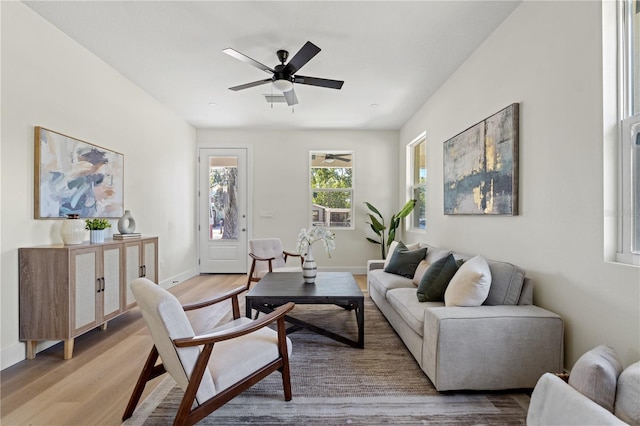 living room with hardwood / wood-style floors and ceiling fan