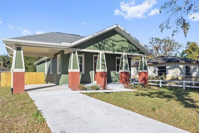 view of front of house featuring covered porch and a front lawn