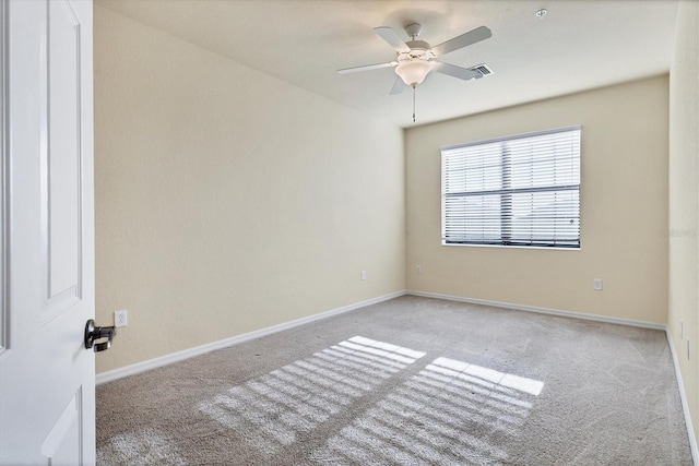 carpeted empty room featuring ceiling fan