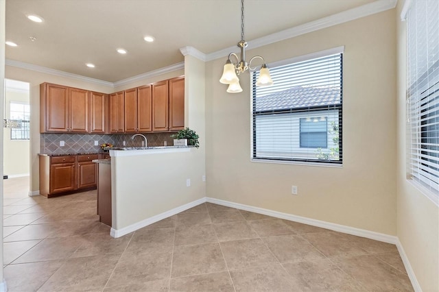 kitchen with backsplash, crown molding, pendant lighting, light tile patterned floors, and a chandelier