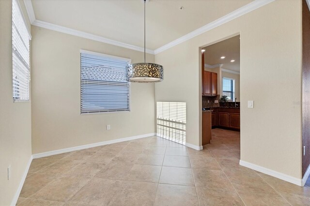 unfurnished dining area with ornamental molding and light tile patterned floors