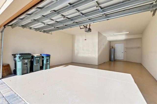 garage featuring electric water heater and a garage door opener