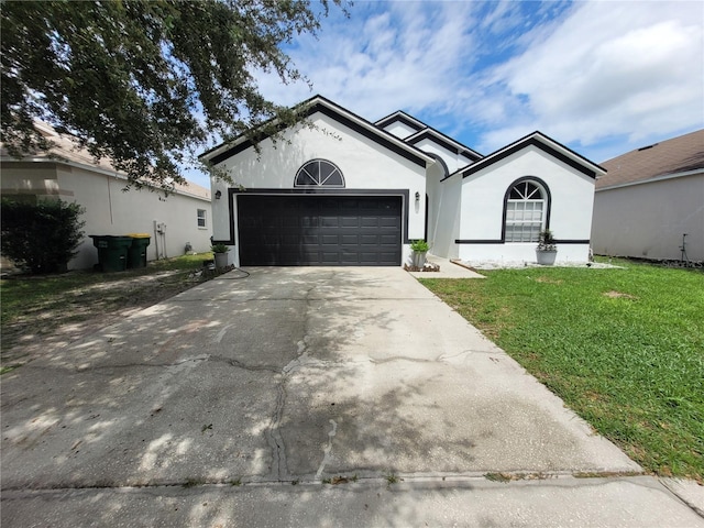 single story home with a front lawn and a garage