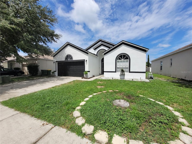 view of front facade featuring a front yard and a garage