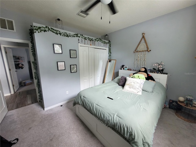 carpeted bedroom featuring a closet and ceiling fan