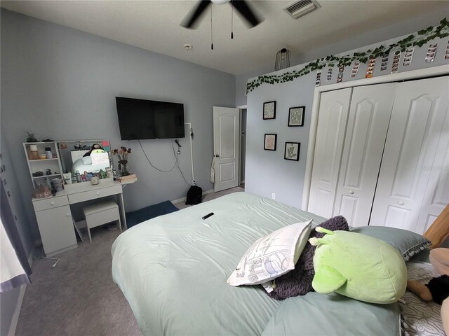 carpeted bedroom featuring a closet and ceiling fan