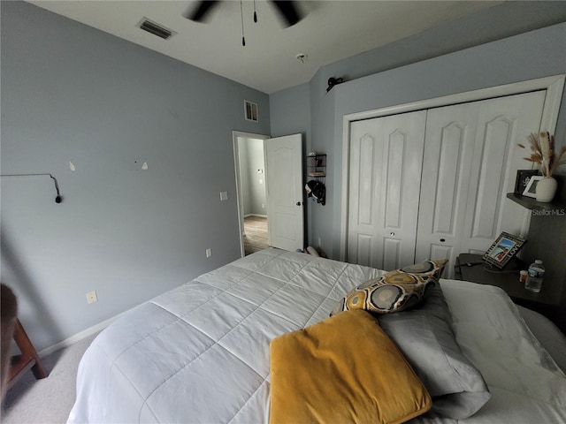 bedroom featuring a closet, ceiling fan, and light colored carpet