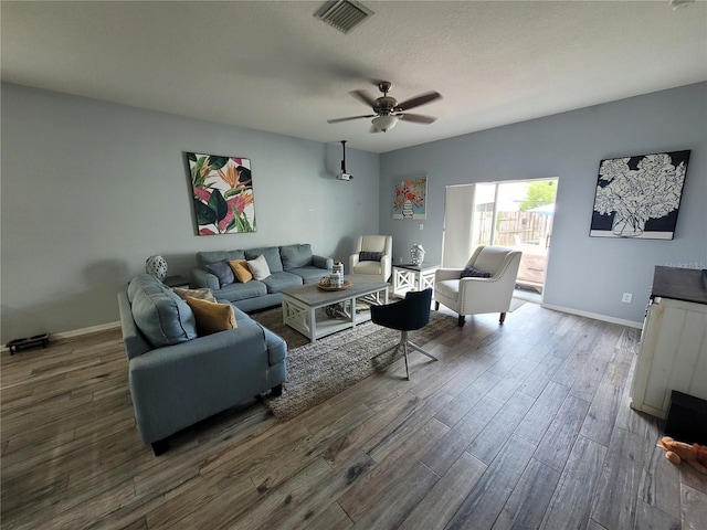 living room with dark hardwood / wood-style floors and ceiling fan