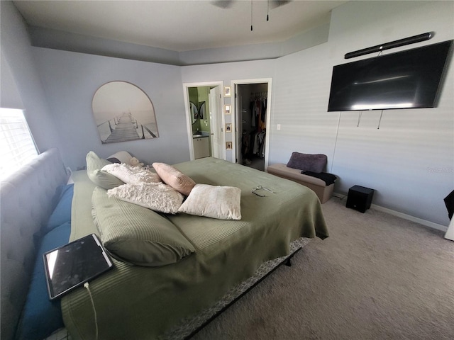 carpeted bedroom featuring a spacious closet, connected bathroom, and a closet