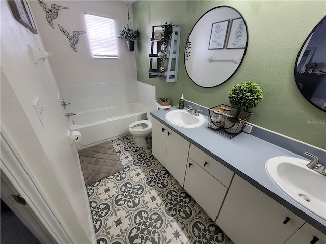 bathroom with vanity, toilet, tile patterned floors, and a washtub