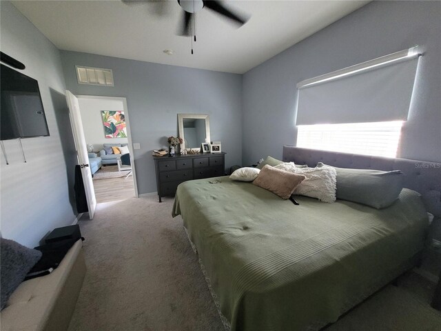 bedroom with ceiling fan and light colored carpet