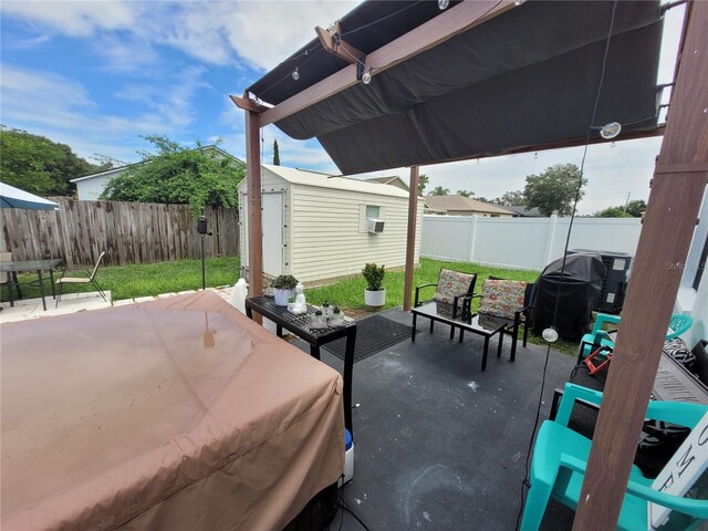 view of patio / terrace with a storage unit, outdoor lounge area, and a grill