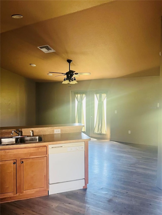 kitchen featuring dark wood-type flooring, ceiling fan, dishwasher, and sink