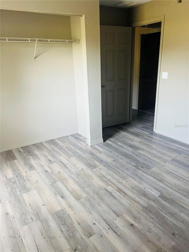 empty room with light hardwood / wood-style flooring