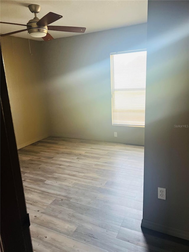 spare room with light hardwood / wood-style floors and ceiling fan