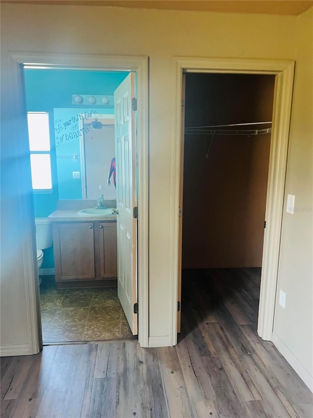 hallway with sink and dark hardwood / wood-style flooring