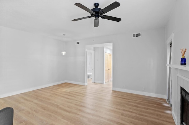 unfurnished living room featuring light hardwood / wood-style flooring and ceiling fan