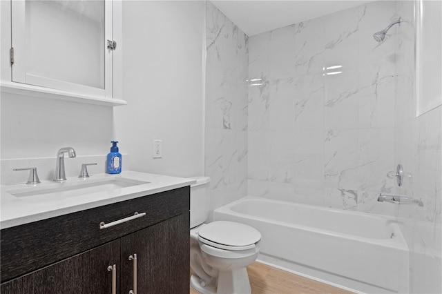 full bathroom with toilet, tiled shower / bath combo, vanity, and wood-type flooring