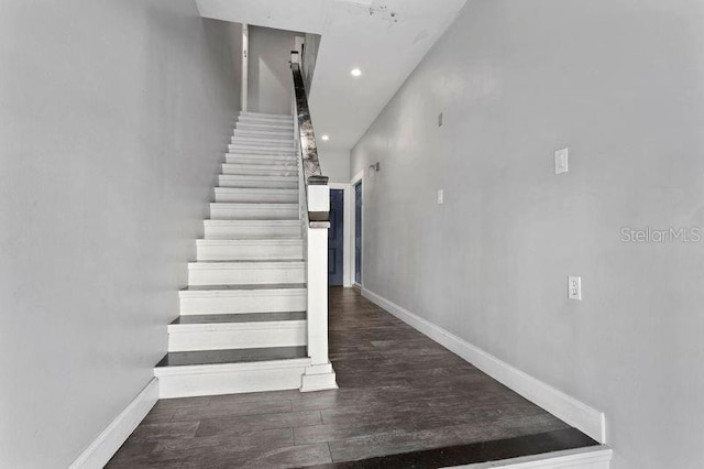 staircase featuring wood-type flooring