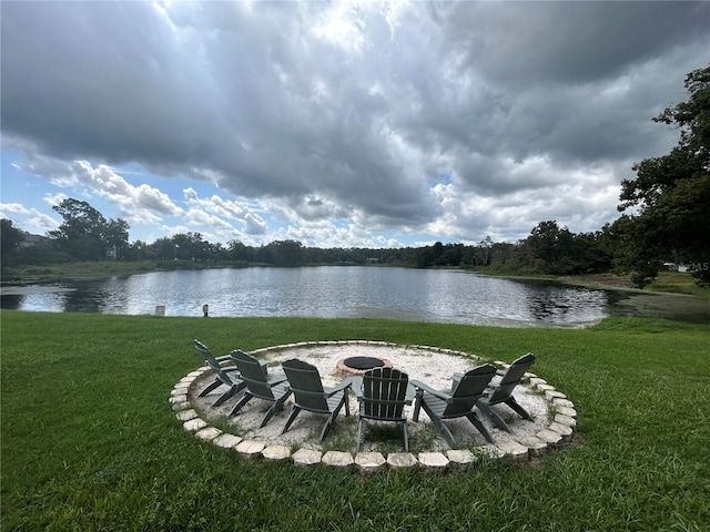 view of yard with an outdoor fire pit and a water view