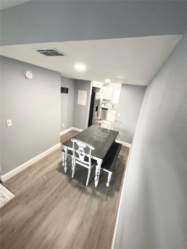 dining space featuring wood-type flooring