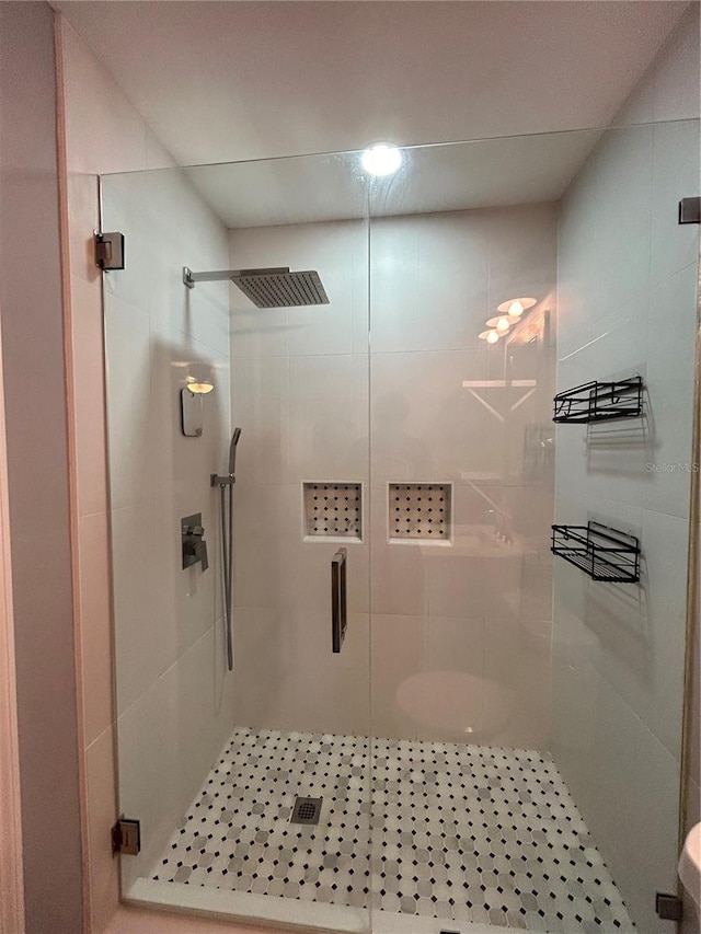 bathroom with toilet and walk in shower