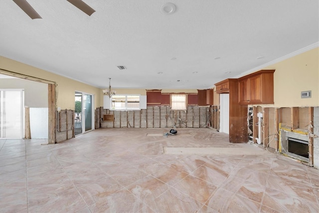 unfurnished living room featuring ornamental molding