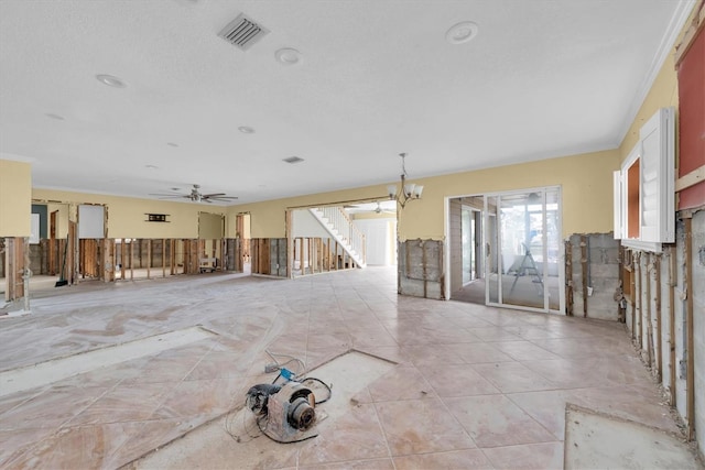 spare room with ceiling fan with notable chandelier and ornamental molding