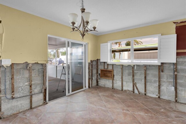 interior space featuring crown molding, light tile patterned floors, and a chandelier