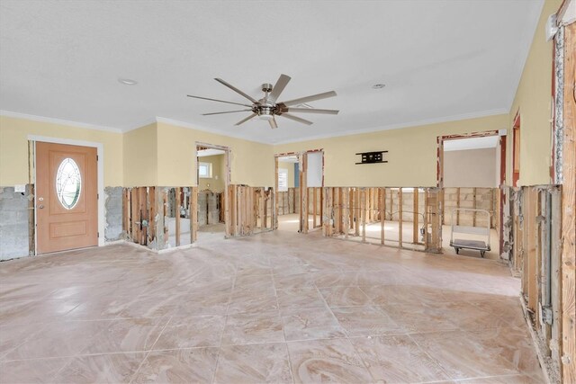 spare room with ceiling fan and ornamental molding