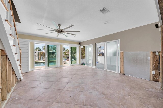 unfurnished living room featuring light tile patterned floors and ceiling fan