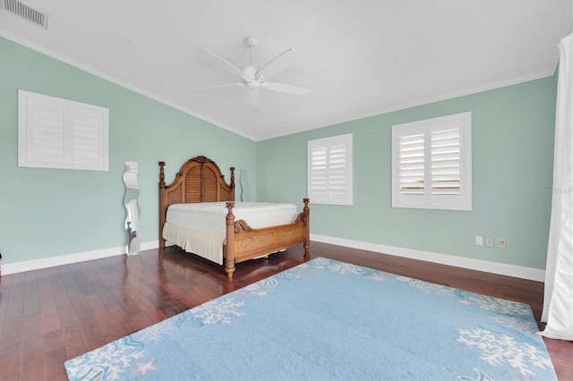 bedroom with ceiling fan, crown molding, and dark wood-type flooring