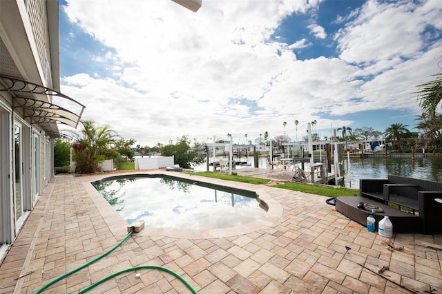 view of pool with a boat dock, a water view, and a patio area