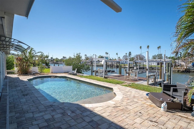 view of pool featuring a patio area, a dock, and a water view