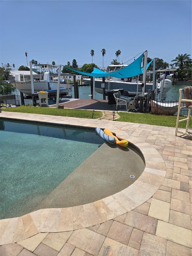 view of swimming pool featuring a water view and a patio area