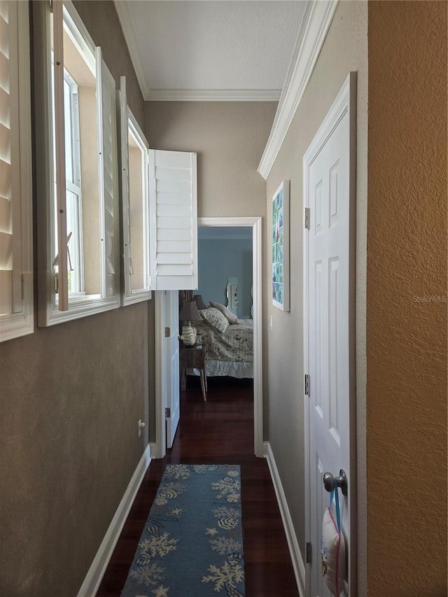 corridor featuring dark hardwood / wood-style flooring and ornamental molding