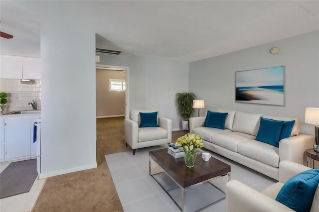 living room with sink and light carpet