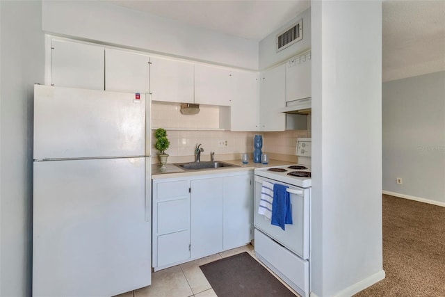 kitchen featuring white cabinets, light tile patterned floors, backsplash, sink, and white appliances