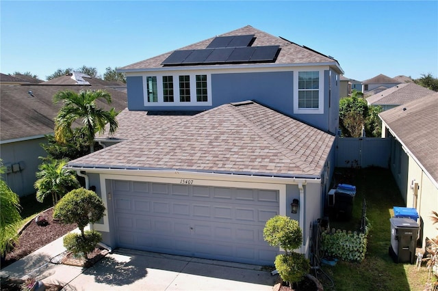 front of property with solar panels and a garage