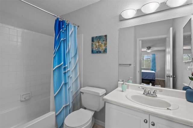 full bathroom featuring vanity, shower / tub combo, toilet, and ceiling fan