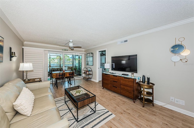 living room featuring light hardwood / wood-style flooring, ornamental molding, a textured ceiling, and ceiling fan