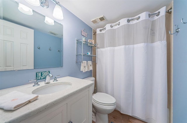 bathroom featuring toilet, vanity, wood-type flooring, and a shower with shower curtain