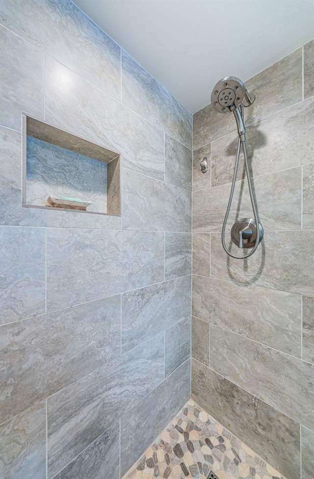 bathroom with a tile shower