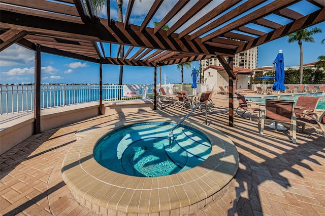 view of swimming pool with a hot tub, a patio area, a water view, and a pergola