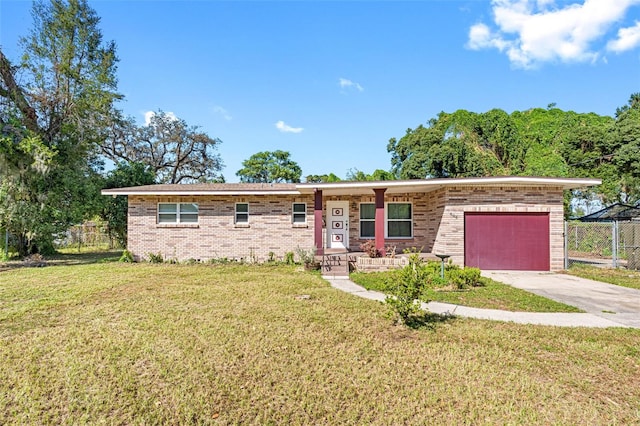 ranch-style home with a garage and a front lawn