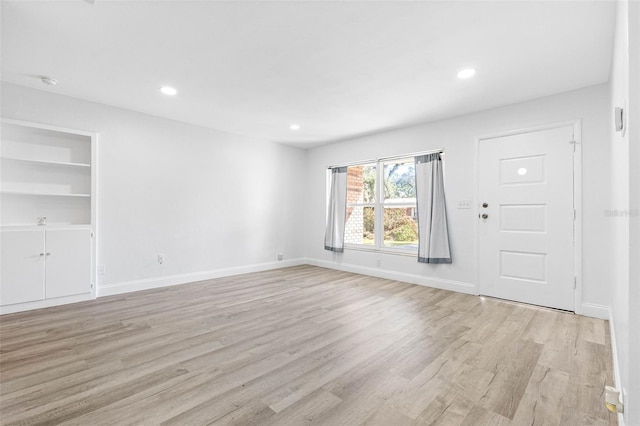 interior space with light hardwood / wood-style floors and built in features