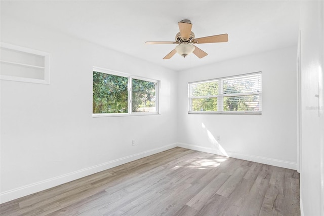 spare room with light wood-type flooring and ceiling fan